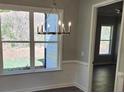 This dining area features a modern chandelier and a view of the outdoors at 3032 Farm Tract Trl, Woodstock, GA 30189