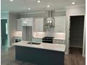 Well-lit kitchen featuring a sizable island, modern appliances, and sleek design at 3032 Farm Tract Trl, Woodstock, GA 30189
