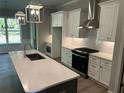 Modern kitchen boasts a spacious island, stainless steel appliances, and ample cabinet space at 3032 Farm Tract Trl, Woodstock, GA 30189