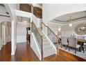 Grand foyer with staircase, hardwood floors, and elegant dining room with chandelier at 3345 Palmer Lake Pointe, Douglasville, GA 30135