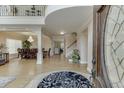 Elegant foyer featuring a grand entrance with a high ceiling, staircase, and a view into the dining area at 380 Chandler Ct, Sugar Hill, GA 30518