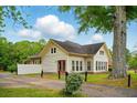 Exterior view of home with a driveway, manicured bushes, and vinyl siding at 426 College E St, Bowdon, GA 30108