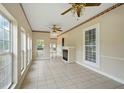 Sun-filled living room with tile floors, a fireplace, and a decorative ceiling fan at 426 College E St, Bowdon, GA 30108