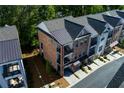 Aerial view of luxury townhomes with brick facades, balconies and attached garages at 451 Burton Dr # 32, Alpharetta, GA 30009