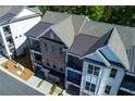 An aerial view of townhomes with brick facades, balconies, and attached garages at 451 Burton Dr # 32, Alpharetta, GA 30009