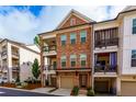 Beautiful brick townhome boasting a two-story design and dual balconies for relaxing outdoor living at 451 Burton Dr # 32, Alpharetta, GA 30009