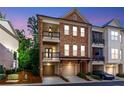 Charming brick townhome featuring a two-story facade and two balconies perfect for outdoor enjoyment at 451 Burton Dr # 32, Alpharetta, GA 30009