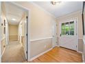 Bright hallway features hardwood floors, neutral walls, white trim, and a glass-paneled door for natural light at 659 Pleasant Hill Nw Rd, Conyers, GA 30012