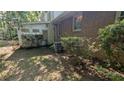 Home exterior with small plantings, brick details, and AC unit at 1349 Cedar Heights Dr, Stone Mountain, GA 30083