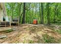 Wooded backyard featuring trees and a small outdoor shed at 507 Lakeshore Dr, Stockbridge, GA 30281