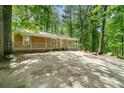 Exterior view of home and spacious front yard surrounded by natural landscape at 507 Lakeshore Dr, Stockbridge, GA 30281