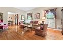 Bright living room boasting hardwood floors, shuttered windows, and classic furnishings at 1405 Murdock Rd, Marietta, GA 30062