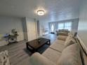 Inviting living room with modern floors, neutral colors, and cozy seating arrangement at 1939 Suwanee Valley Rd, Lawrenceville, GA 30043