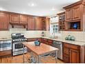 Well-equipped kitchen with stainless steel appliances, custom cabinets, granite countertops, and a functional island at 2178 Tanglewood Rd, Decatur, GA 30033