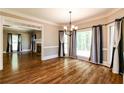 Dining room featuring hardwood floors, chandelier and large windows with stylish curtains at 349 Harris Loop, Dallas, GA 30157