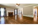 Elegant living room with fireplace and hardwood floors with views into other rooms at 349 Harris Loop, Dallas, GA 30157