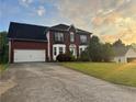 Attractive two-story red brick home with a well-maintained lawn and a spacious driveway at 3511 Autumn Farm Ter, Buford, GA 30519