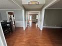 Inviting foyer with gleaming hardwood floors and views into the living spaces at 3511 Autumn Farm Ter, Buford, GA 30519
