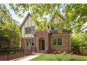 Charming brick two-story home featuring a gable roof, dormer windows, and a nicely landscaped front yard at 134 Woodlawn Ave, Decatur, GA 30030