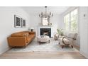 Bright living room with fireplace, modern chandelier, hardwood floors, and stylish furniture at 134 Woodlawn Ave, Decatur, GA 30030
