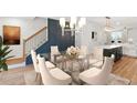 Modern dining room with a clear table, stylish chandelier, and accent wall at 2215 Nena Way # 20, Tucker, GA 30084