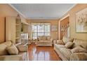 Cozy living room featuring hardwood floors, neutral walls, and comfortable, patterned sofas at 238 Diamond Valley Pass, Canton, GA 30114