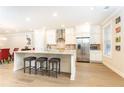 Stylish kitchen featuring a large island with bar seating, modern appliances, and a herringbone backsplash at 555 Letchas Ln, Alpharetta, GA 30009