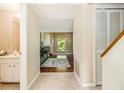 Bright hallway offering views into the living room featuring a fireplace at 11 Forrest Pl, Atlanta, GA 30328
