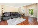 Cozy living room featuring a fireplace and plush gray sofa with blanket and pillows at 11 Forrest Pl, Atlanta, GA 30328