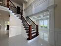 Elegant foyer with iron-and-wood staircase, marble floors, and decorative moldings at 1417 Wind Chime Ct, Lawrenceville, GA 30045