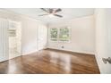 Bright bedroom with hardwood floors, a ceiling fan, and an attached bathroom at 2429 Sherbrooke Ne Ct, Atlanta, GA 30345