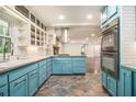 Open kitchen with stainless steel appliances, custom cabinets, and tile floors at 2429 Sherbrooke Ne Ct, Atlanta, GA 30345