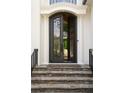 Elegant iron front door with stone steps and decorative columns at 5625 Buckleigh Pointe, Suwanee, GA 30024