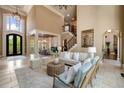 Inviting living room with soaring ceilings, grand staircase, and decorative chandelier at 5625 Buckleigh Pointe, Suwanee, GA 30024