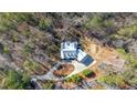 Aerial view of a brick home nestled among mature trees with a circular driveway at 239 Trail Nw Rd, Marietta, GA 30064