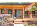 Inviting front porch with brick steps, wood ceiling, hanging flowers, and a decorative wreath at 2981 Cardinal Lake Dr, Duluth, GA 30096