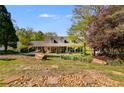 Beautiful home with well-manicured landscaping, showcasing a stone pathway and vibrant flower beds at 317 Ellenwood Dr, Bowdon, GA 30108