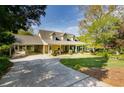 Spacious home with a long driveway, covered carport, and inviting front porch with rocking chairs at 317 Ellenwood Dr, Bowdon, GA 30108