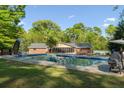 Backyard pool with slide, ladders and spacious deck plus home's sunroom and outdoor cooking area, ideal for summer entertaining at 3833 Coral Ln, Douglasville, GA 30135