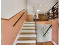 View of the staircase with wood steps and iron railing, transitioning to the upper and lower levels at 3990 Admiral Dr, Chamblee, GA 30341
