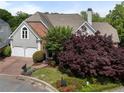 Attractive two-story home with a brick and stucco front, arched window, a two-car garage, and landscaped yard at 4223 Wieuca Overlook Ne, Atlanta, GA 30342