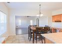 Bright dining area features tile flooring, a wooden table, and natural light from a window at 6980 Talkeetna Sw Ct, Atlanta, GA 30331