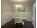 Bright dining room featuring modern lighting, wainscoting, and sleek table setup at 82 Hinton Farm Way, Dacula, GA 30019