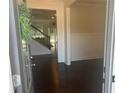Elegant foyer with hardwood floors and staircase, showcasing the home's open layout and design at 82 Hinton Farm Way, Dacula, GA 30019