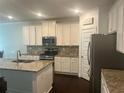 Modern kitchen with stainless steel appliances, granite countertops, and ample cabinet space at 82 Hinton Farm Way, Dacula, GA 30019
