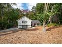 View of home nestled in wooded area with lush foliage, and long driveway at 2377 Emory Ln, Marietta, GA 30068