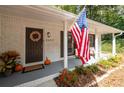 Charming front porch featuring a decorative wreath, an American flag, seating, and seasonal decorations at 2377 Emory Ln, Marietta, GA 30068