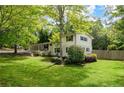 Well-manicured lawn and landscaped yard showcase this two-story home with white brick and dark shutters at 3383 Campbell Se Rd, Smyrna, GA 30080