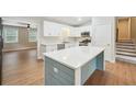 Kitchen featuring a center island with quartz countertop, stainless steel appliances, and sleek white cabinets at 798 Bankshire Dr, Suwanee, GA 30024
