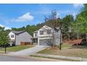 View of a well-maintained two-story home with a neat lawn and a two-car garage at 820 Lake Chase, Fairburn, GA 30213